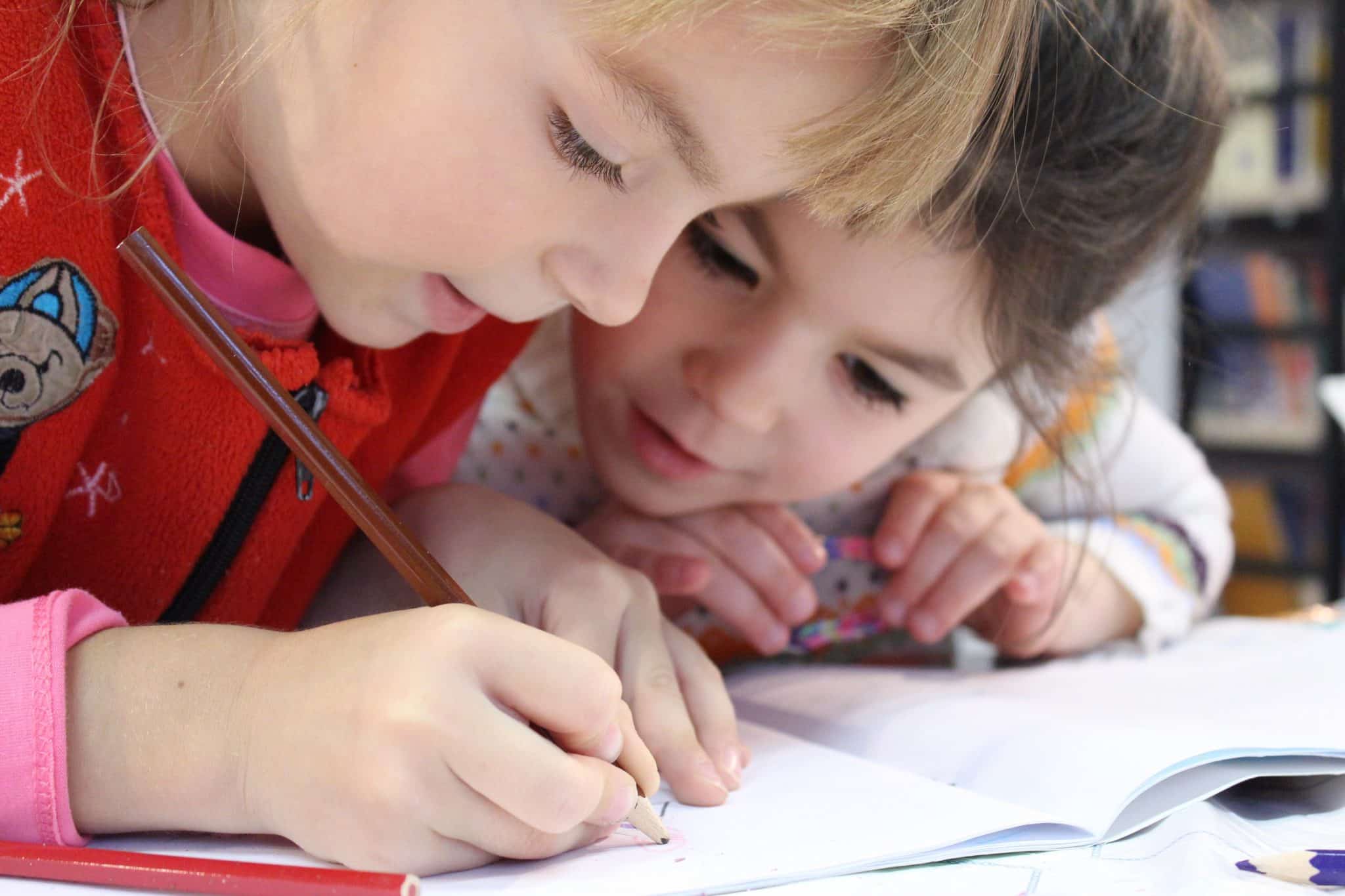 Girls On Desk Looking At Notebook 159823 - Coach Foundation